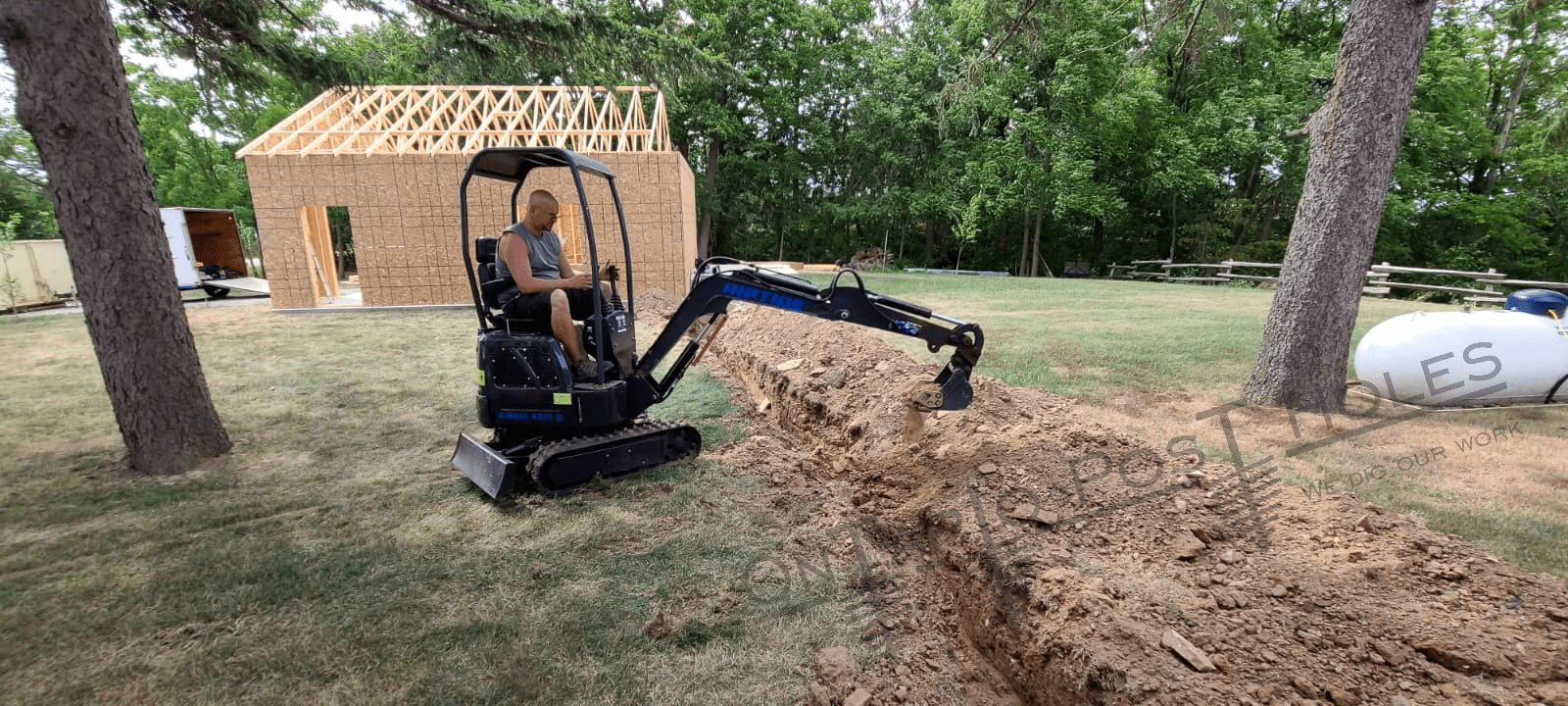 Mini excavator digging into the ground